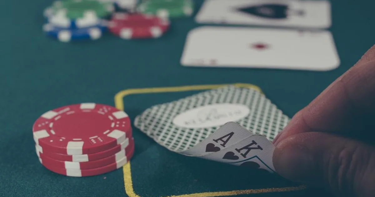 A spread of playing cards on a table, the subject of how many shuffles randomize a deck.